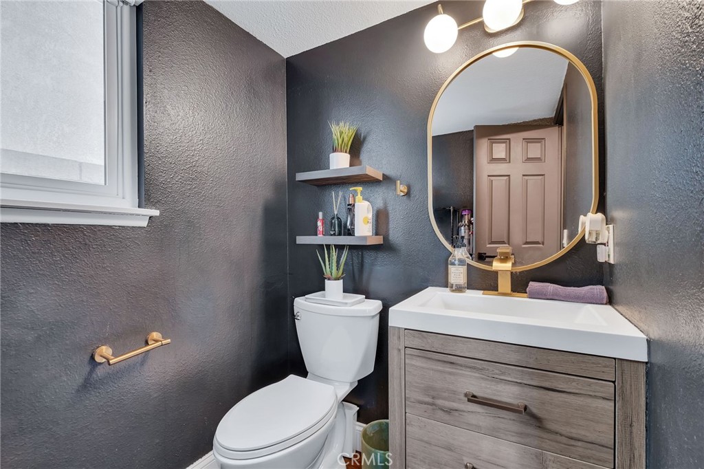 1780 North Azure Street Anaheim, CA 92807 - Photo 34 of 68 a bathroom with a toilet a sink and mirror