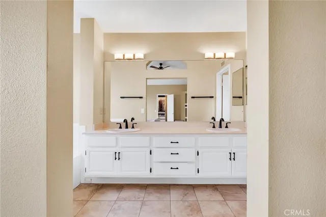 a bathroom with a double vanity sink and a mirror