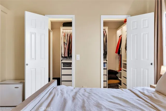 a bedroom with a bed and large window