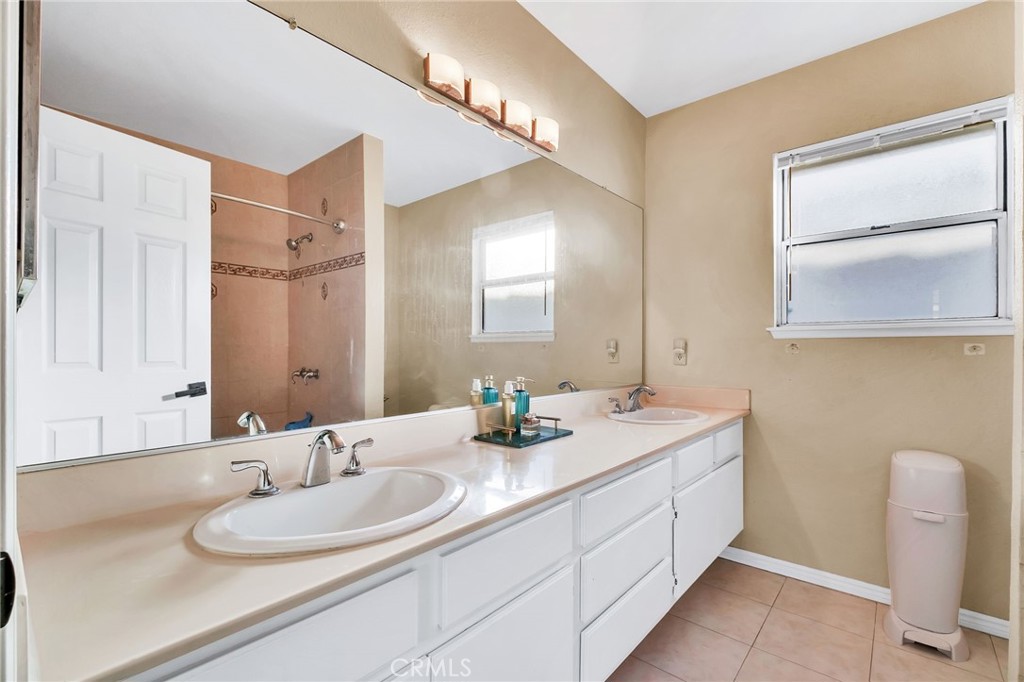 1780 North Azure Street Anaheim, CA 92807 - Photo 45 of 68 a bathroom with a double vanity sink and a mirror