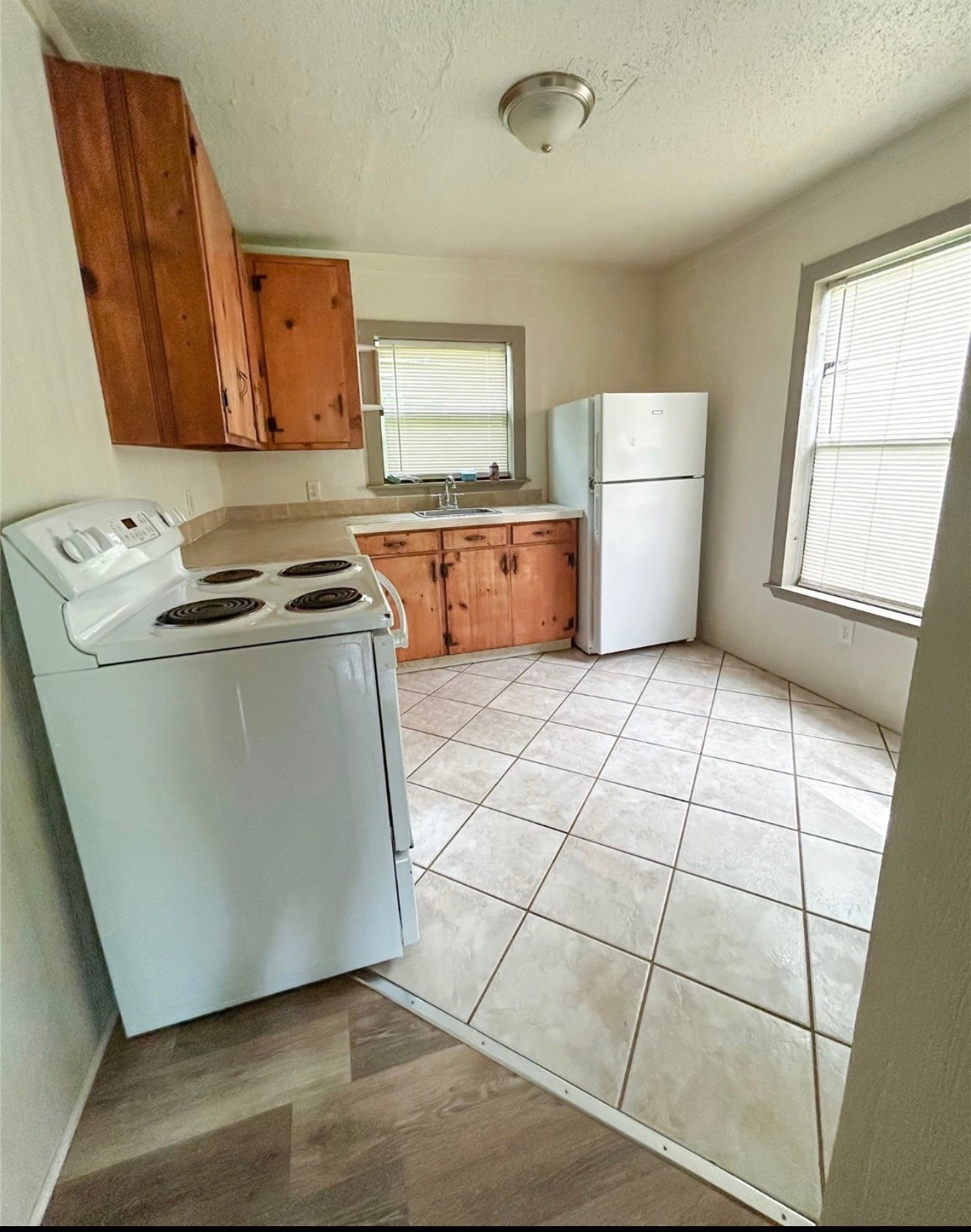 3005 Old Houston Road, Unit C Huntsville, TX 77340 - Photo 2 of 4 a kitchen with stainless steel appliances granite countertop a stove a sink and a refrigerator