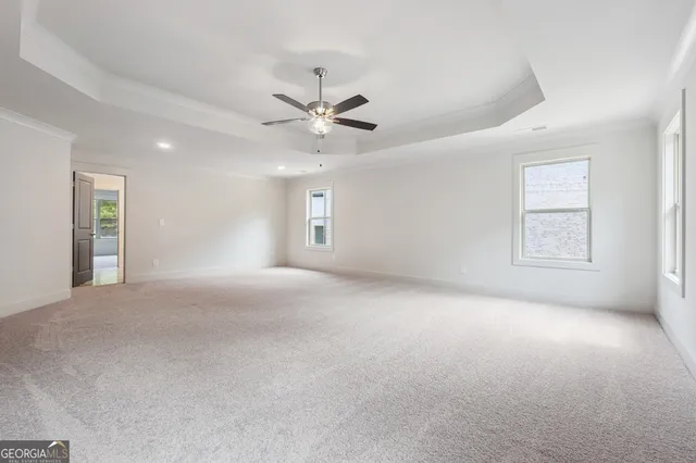 a view of a livingroom with a ceiling fan and window