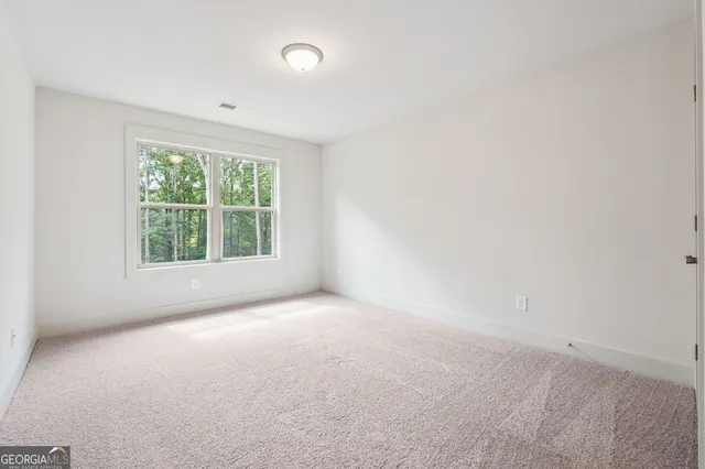 an empty room with windows and yard