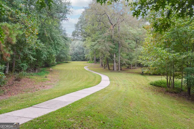 a view of a backyard with large trees