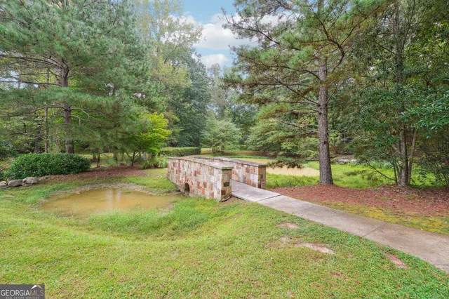 a swimming pool with outdoor seating and yard