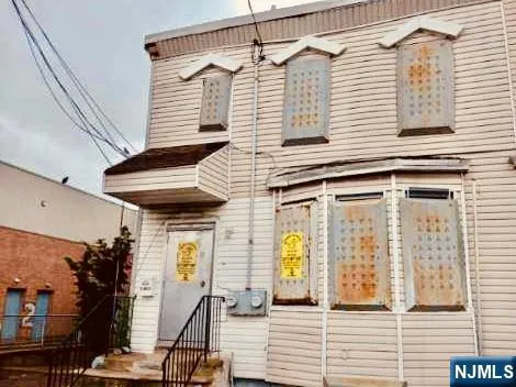 a view of a house with wooden deck