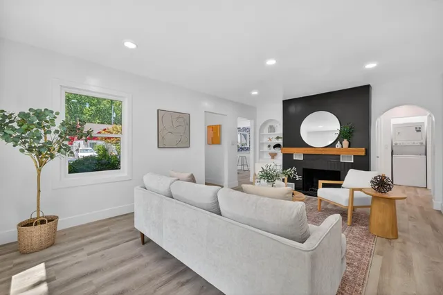 a living room with furniture and a large mirror