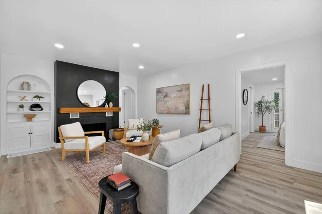 a living room with furniture and a wooden floor