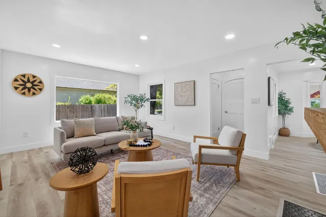 a living room with furniture and wooden floor