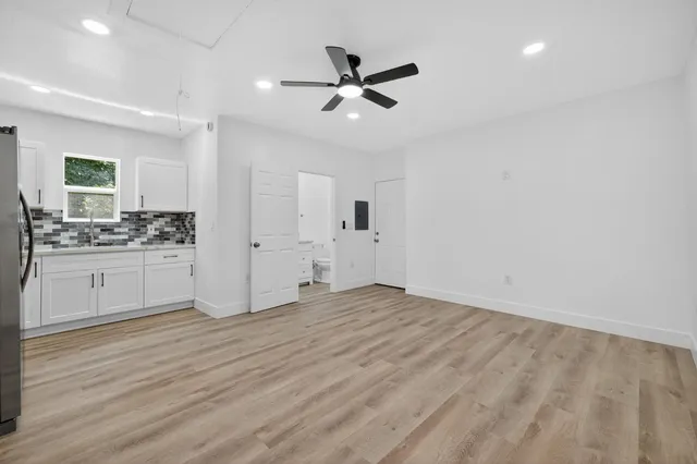 a view of kitchen with granite countertop cabinets and white appliances