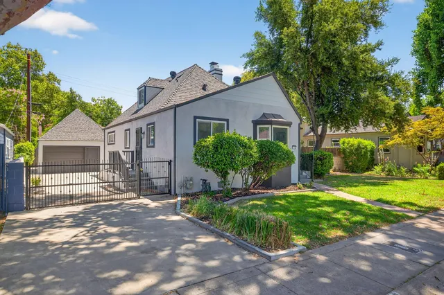 a front view of house with yard and green space