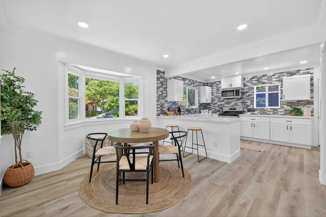 a kitchen with a table and chairs in it