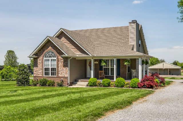 510 Dorris Road Portland, TN 37148 - Photo 1 of 20 a front view of a house with a garden and plants