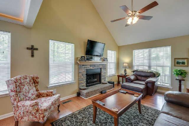510 Dorris Road Portland, TN 37148 - Photo 20 of 20 a living room with furniture a fireplace and a flat screen tv