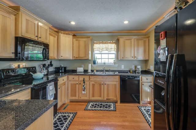 510 Dorris Road Portland, TN 37148 - Photo 5 of 20 a large kitchen with stainless steel appliances granite countertop a stove a sink dishwasher a refrigerator and a microwave