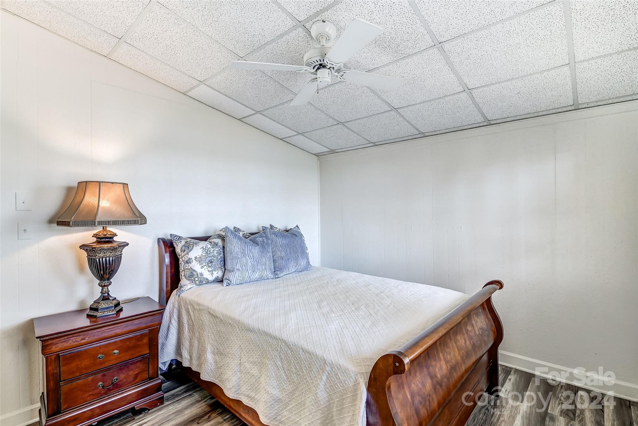 8303 Luckey Point Road Denver, NC 28037 - Photo 21 of 40 a bedroom with a bed and wooden floor