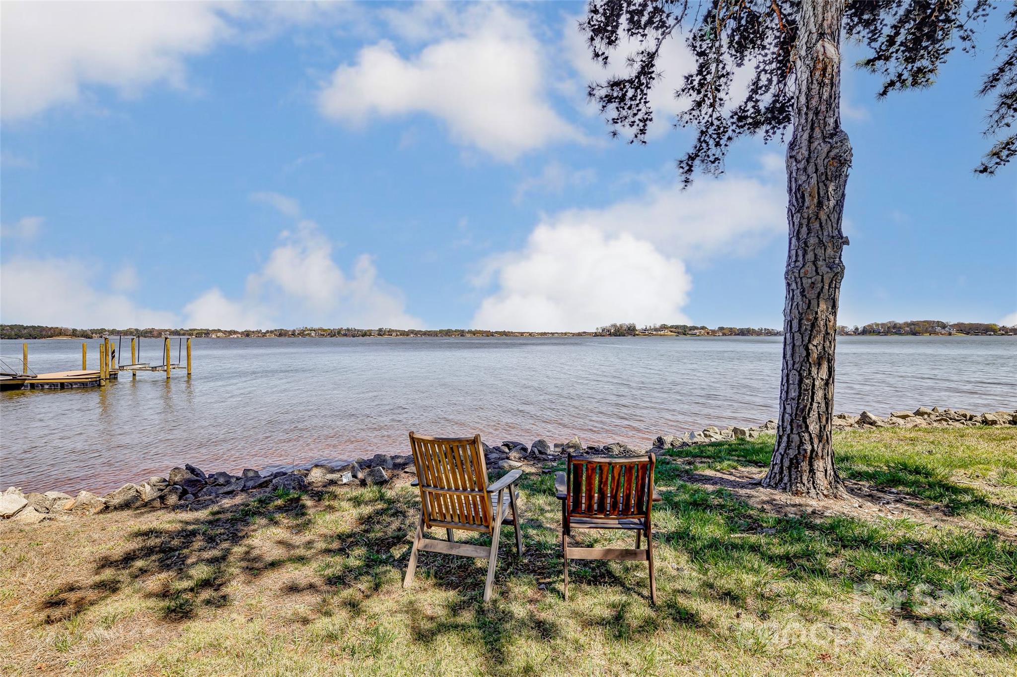8303 Luckey Point Road Denver, NC 28037 - Photo 4 of 40 a view of a lake with a table under an umbrella