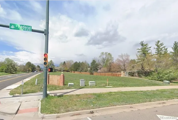 a front view of a house with a yard and lake view