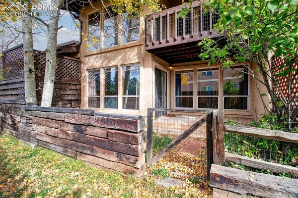 front view of house with a window and a tree