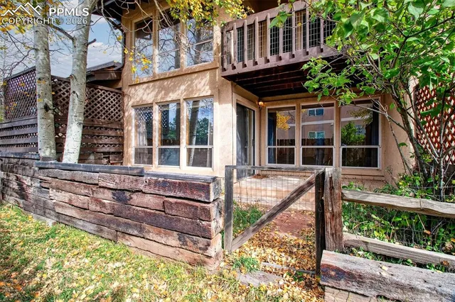 front view of house with a window and a tree