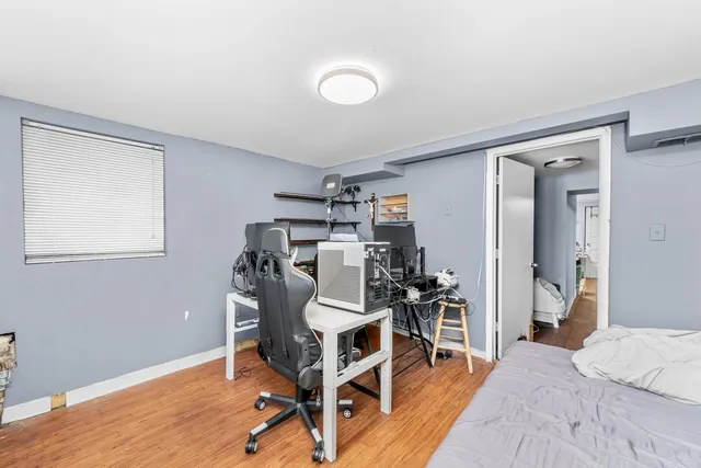 a view of a workspace with furniture and wooden floor