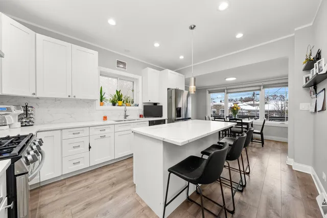 a kitchen with a table chairs stove and cabinets