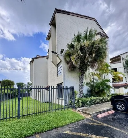 a view of a house with a yard and a garden