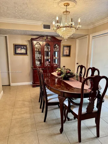 a view of a dining room with furniture and chandelier