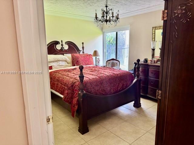 8933 Southwest 123rd Court, Unit 102 Miami, FL 33186 - Photo 16 of 19 a bed sitting in a bedroom next to a window