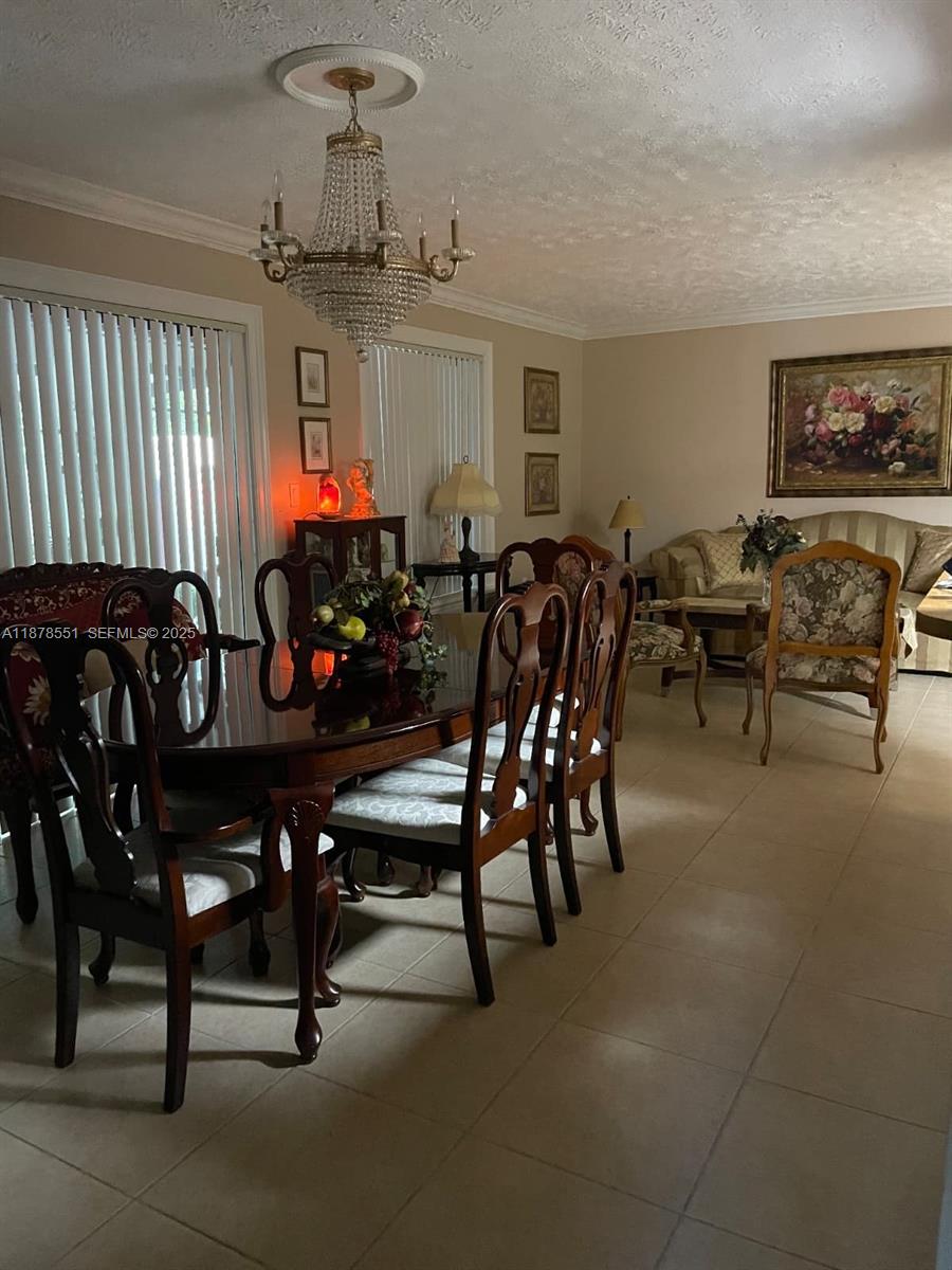 8933 Southwest 123rd Court, Unit 102 Miami, FL 33186 - Photo 18 of 19 a view of a dining room with furniture window and outside view