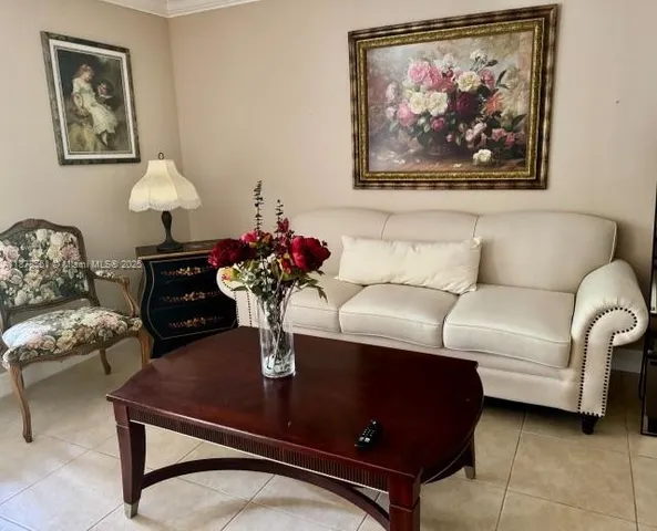 a living room with furniture and a lamp