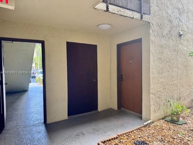 8933 Southwest 123rd Court, Unit 102 Miami, FL 33186 - Photo 6 of 19 a view of hallway with livingroom and bedroom