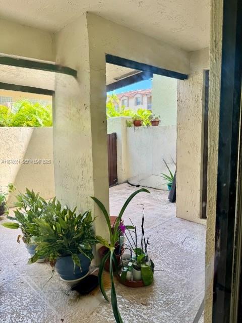8933 Southwest 123rd Court, Unit 102 Miami, FL 33186 - Photo 7 of 19 a view of a entryway with flower pots