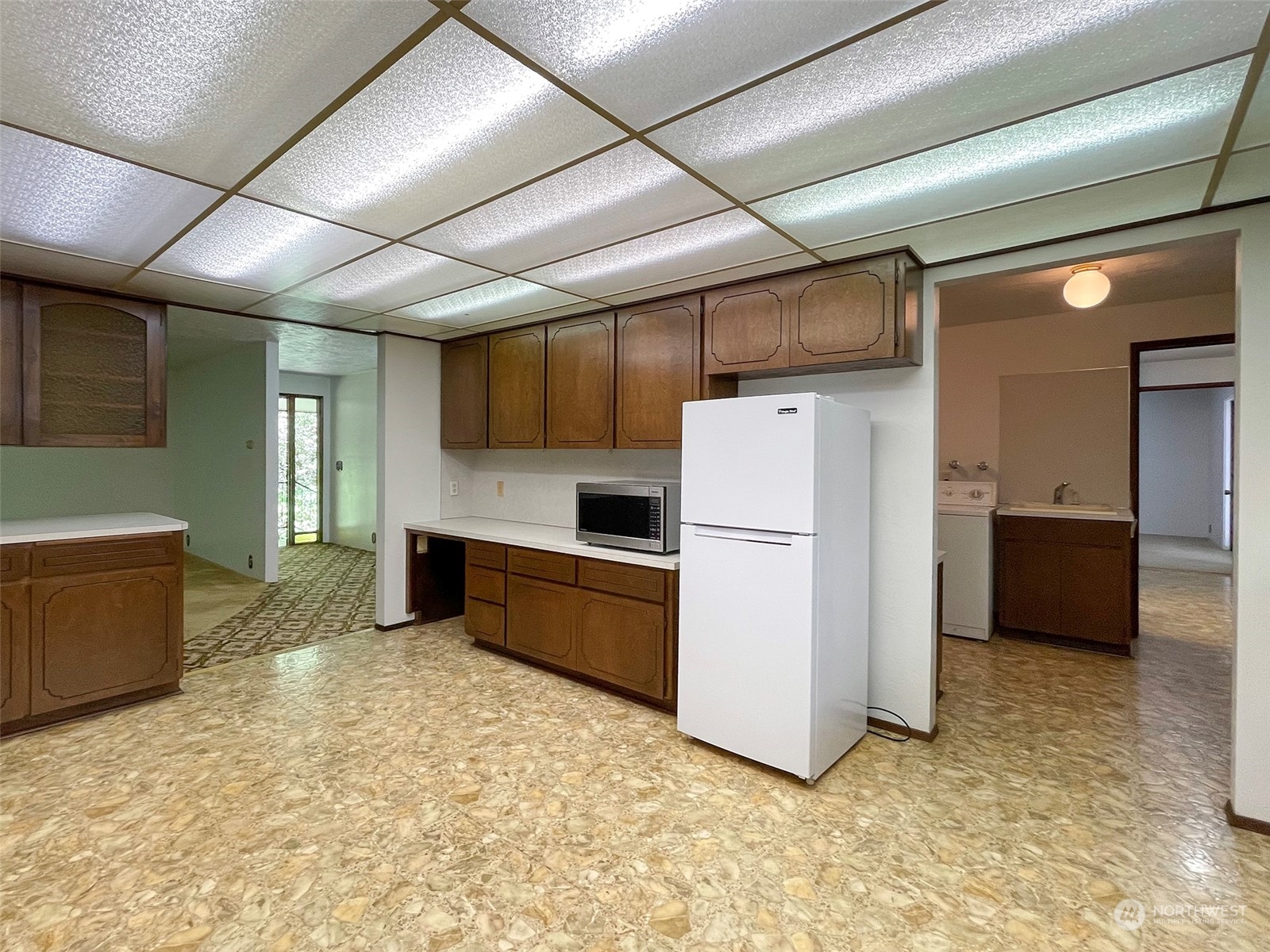 104 Waldo Road Sequim, WA 98382 - Photo 15 of 40 a kitchen with refrigerator cabinets and a sink