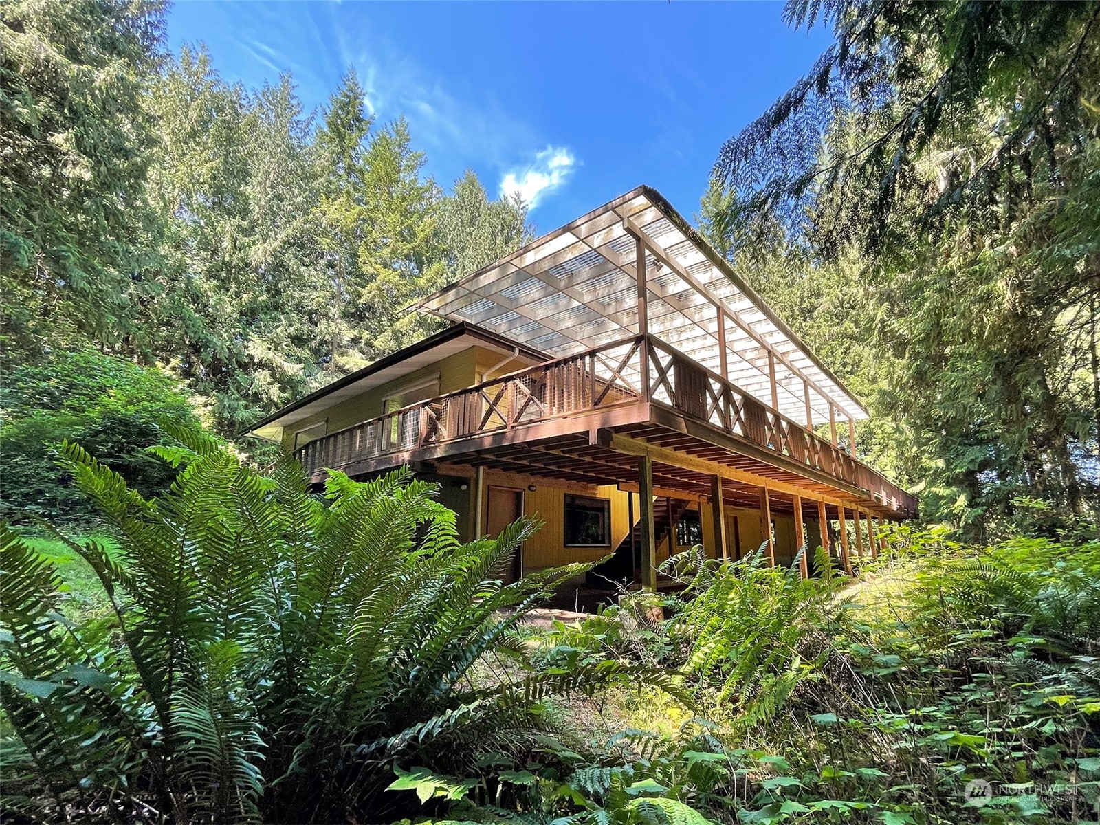 104 Waldo Road Sequim, WA 98382 - Photo 2 of 40 a front view of a house with a yard and trees