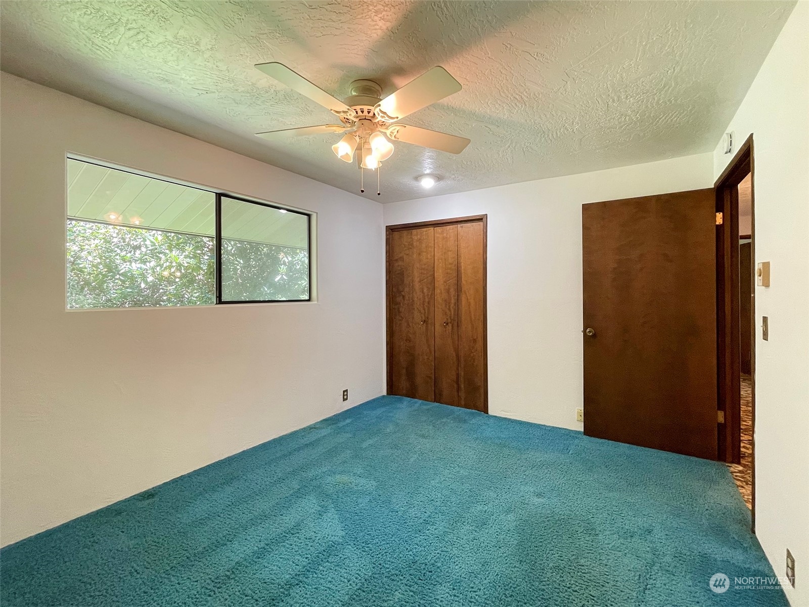 104 Waldo Road Sequim, WA 98382 - Photo 21 of 40 an empty room with chandelier fan and windows