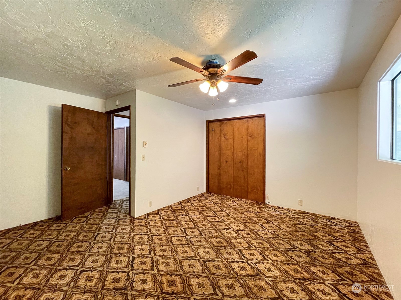 104 Waldo Road Sequim, WA 98382 - Photo 23 of 40 a bedroom with a bed and a chandelier