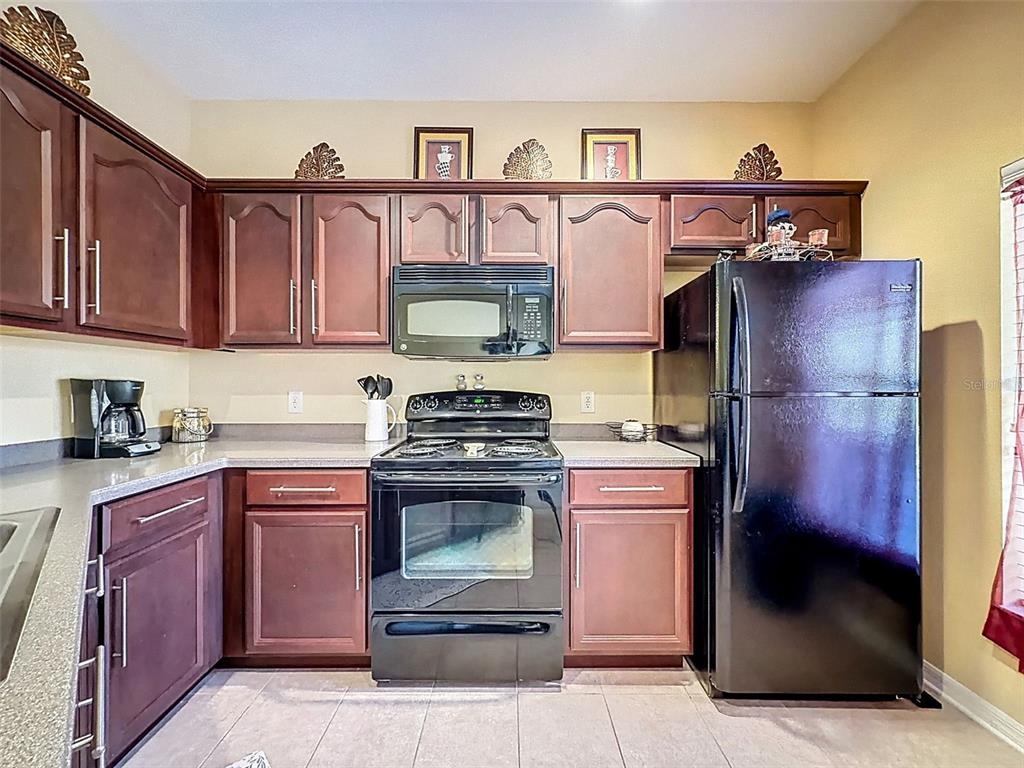 11807 Castine Street New Port Richey, FL 34654 - Photo 6 of 40 a kitchen with stainless steel appliances granite countertop a stove and a refrigerator