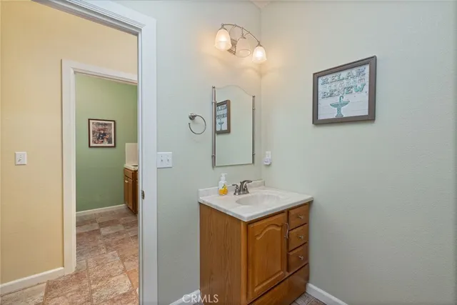 a bedroom with a bed a rug and wooden floor