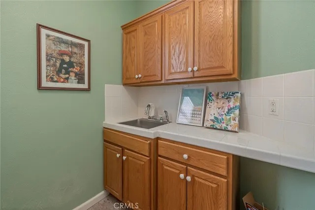 a view of a roof deck with couches and wooden floor
