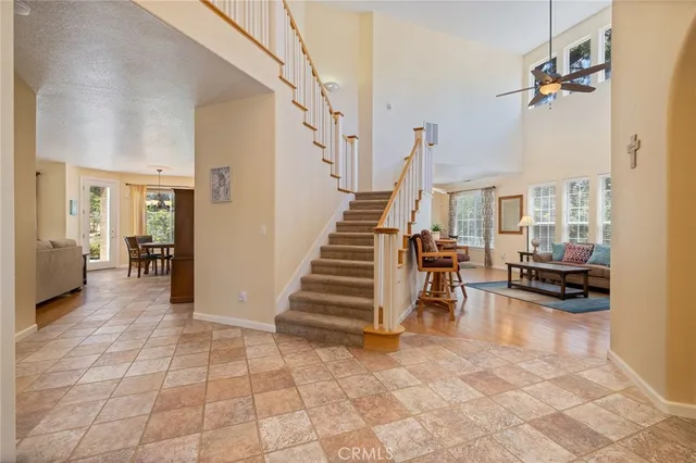 a living room with furniture and a dining table with wooden floor