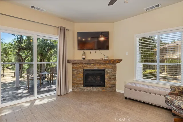 a view of an empty room with a window and a fireplace