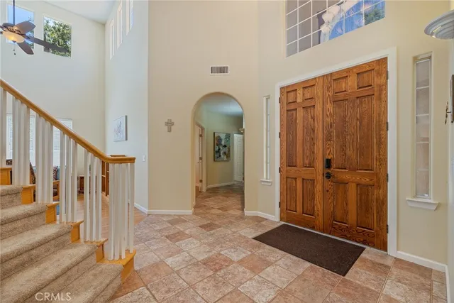 a dining room with furniture a chandelier and wooden floor