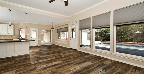 a spacious bedroom with a bed a couch and a flat tv