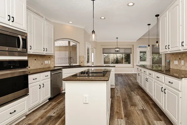 a view of a room with wooden floor and windows