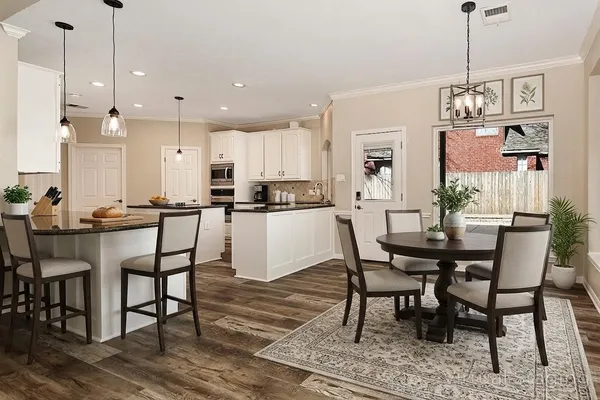 a living room with furniture a large window and a fireplace