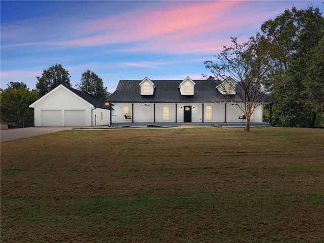 a view of house with outdoor space and garden