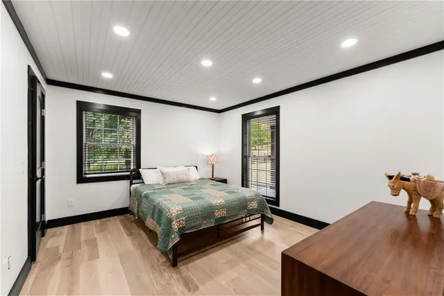 a kitchen with stainless steel appliances kitchen island granite countertop a table chairs in it and wooden floors