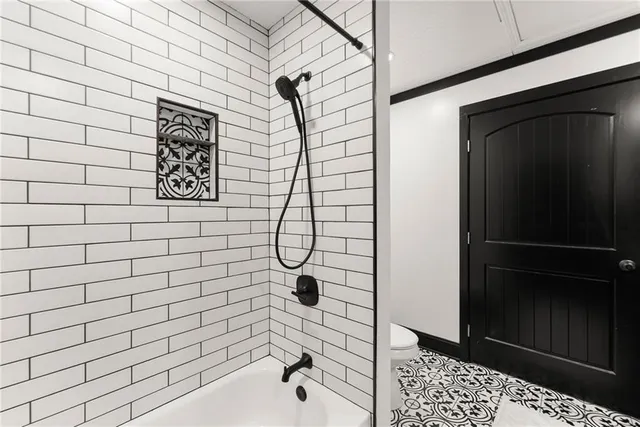 a kitchen with stainless steel appliances granite countertop a refrigerator a sink dishwasher a stove top oven and refrigerator