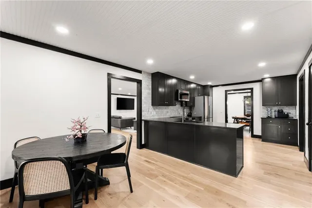 a bed sitting in a spacious bedroom next to a window